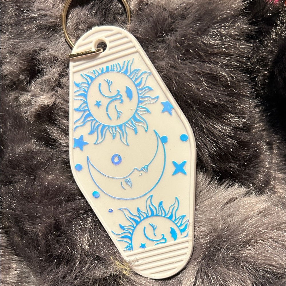White Keychain with Blue Sun and Moon Design